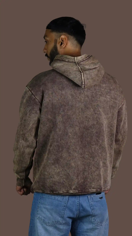 Man wearing a Acid wash brown hoodie on a brown background
