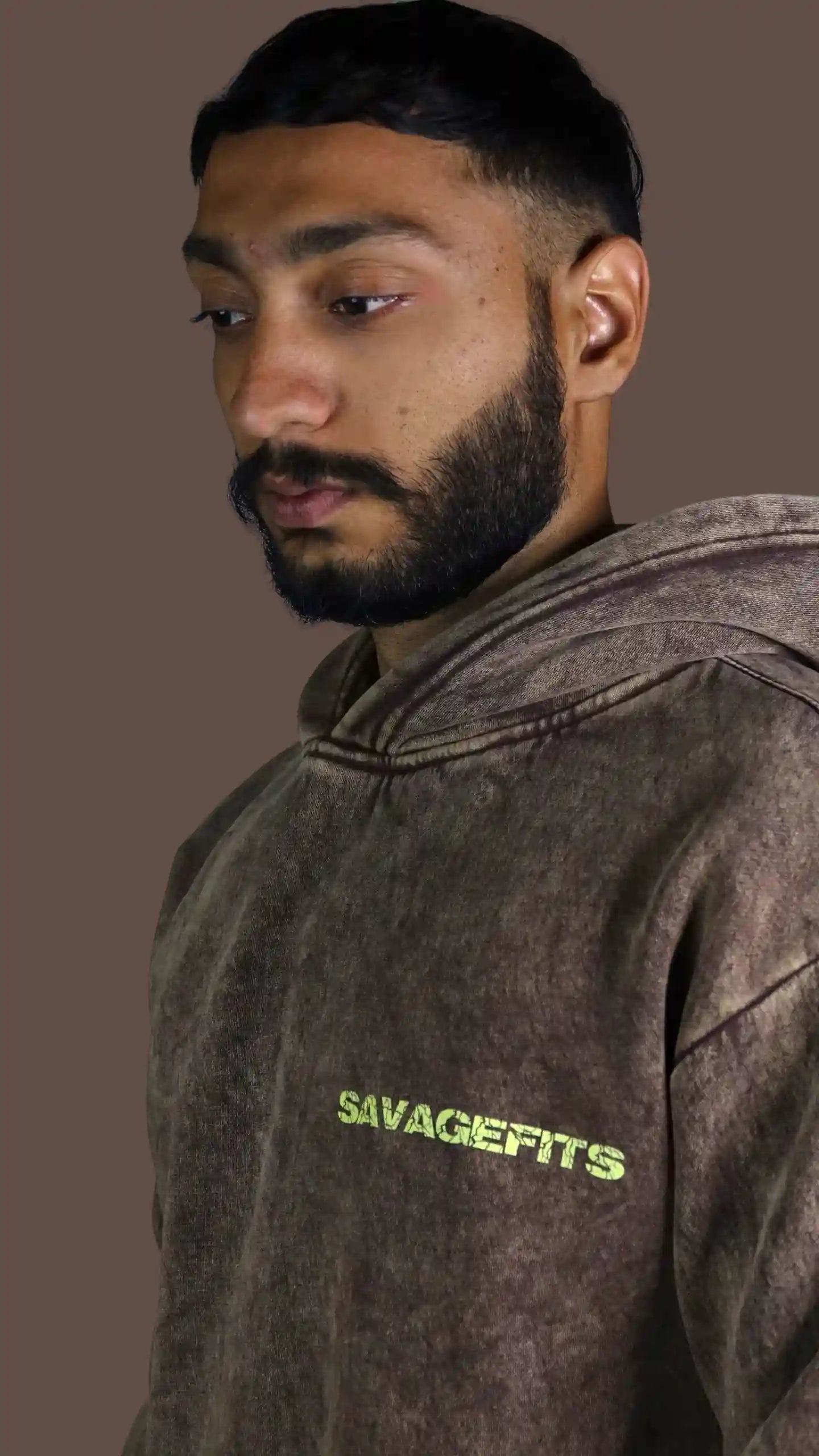 Man wearing a brown Acid wash hoodie with 'Savagefits' logo on a brown background