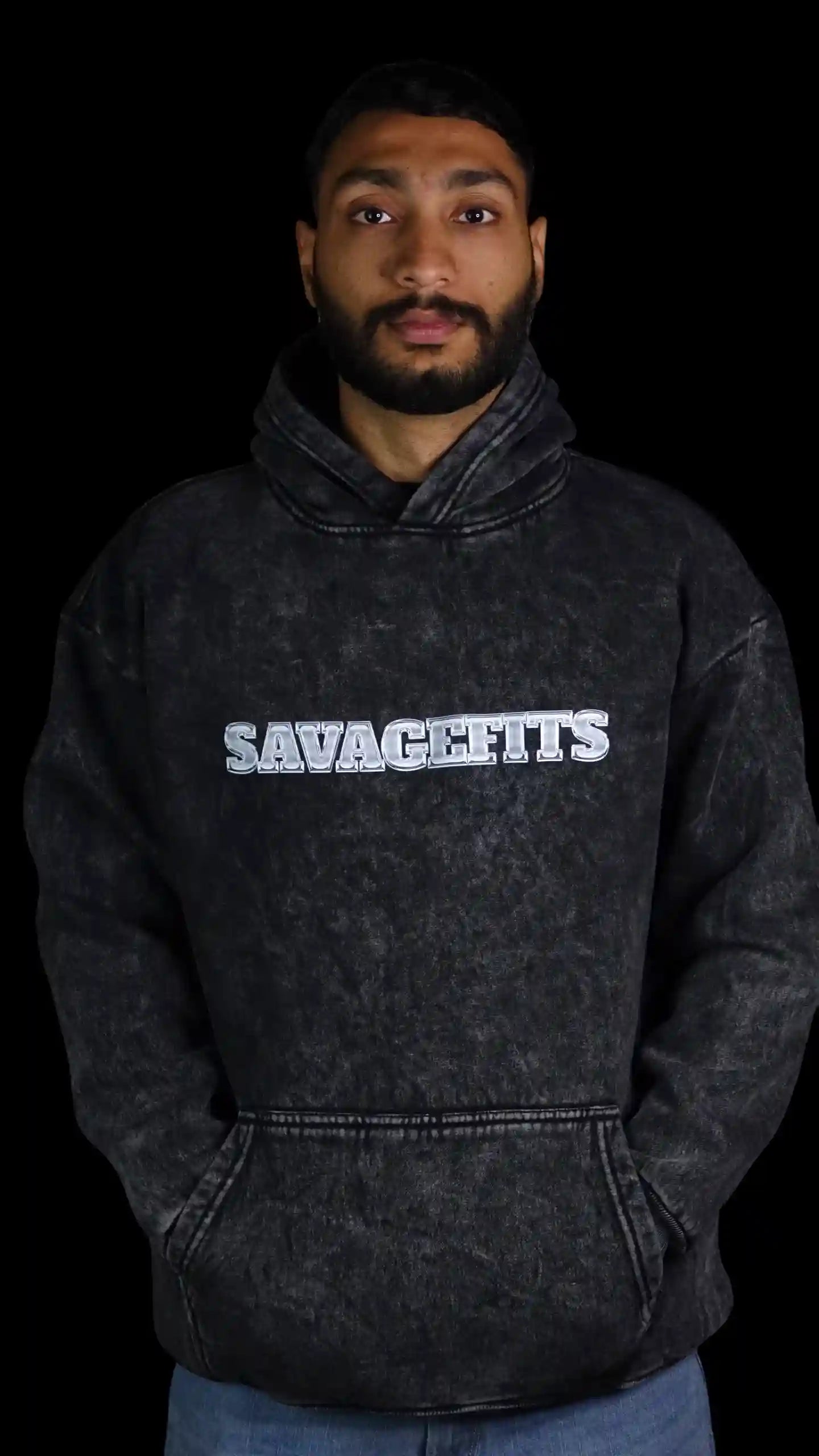 Person wearing a Acid wash gray hoodie with 'SAVAGEFITS' text on a black background