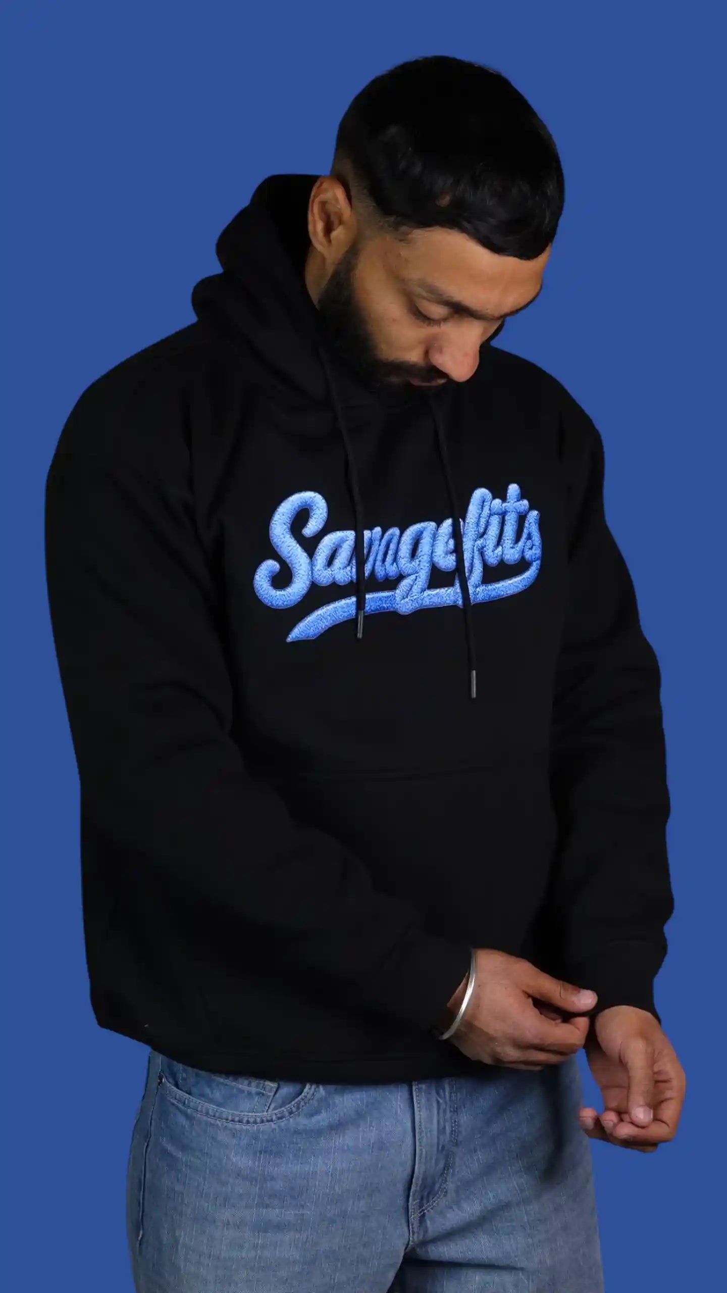 Person wearing a black hoodie with 'Savagefits' text on a blue background