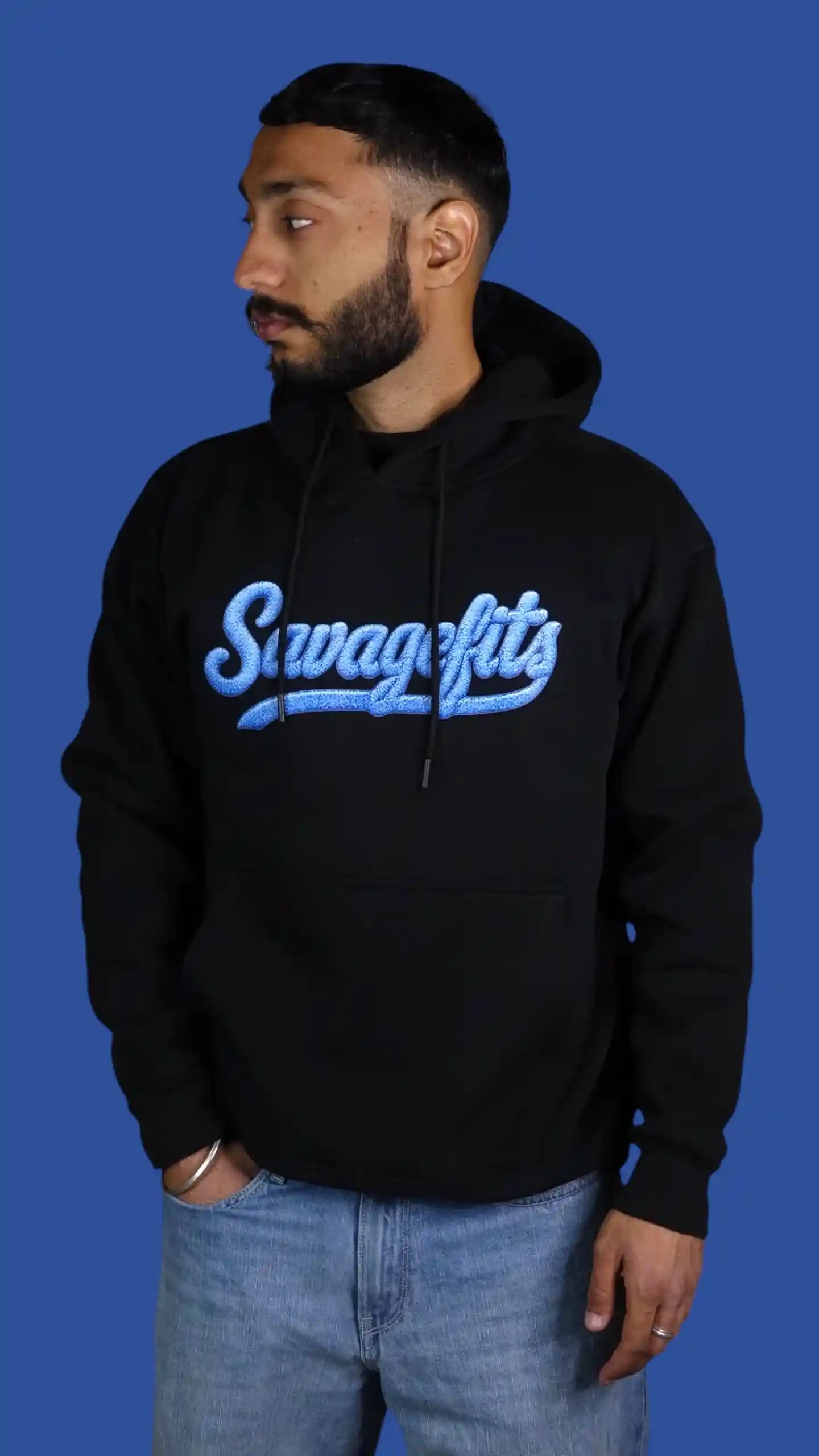 Man wearing a black hoodie with 'Savagefits' logo on a blue background