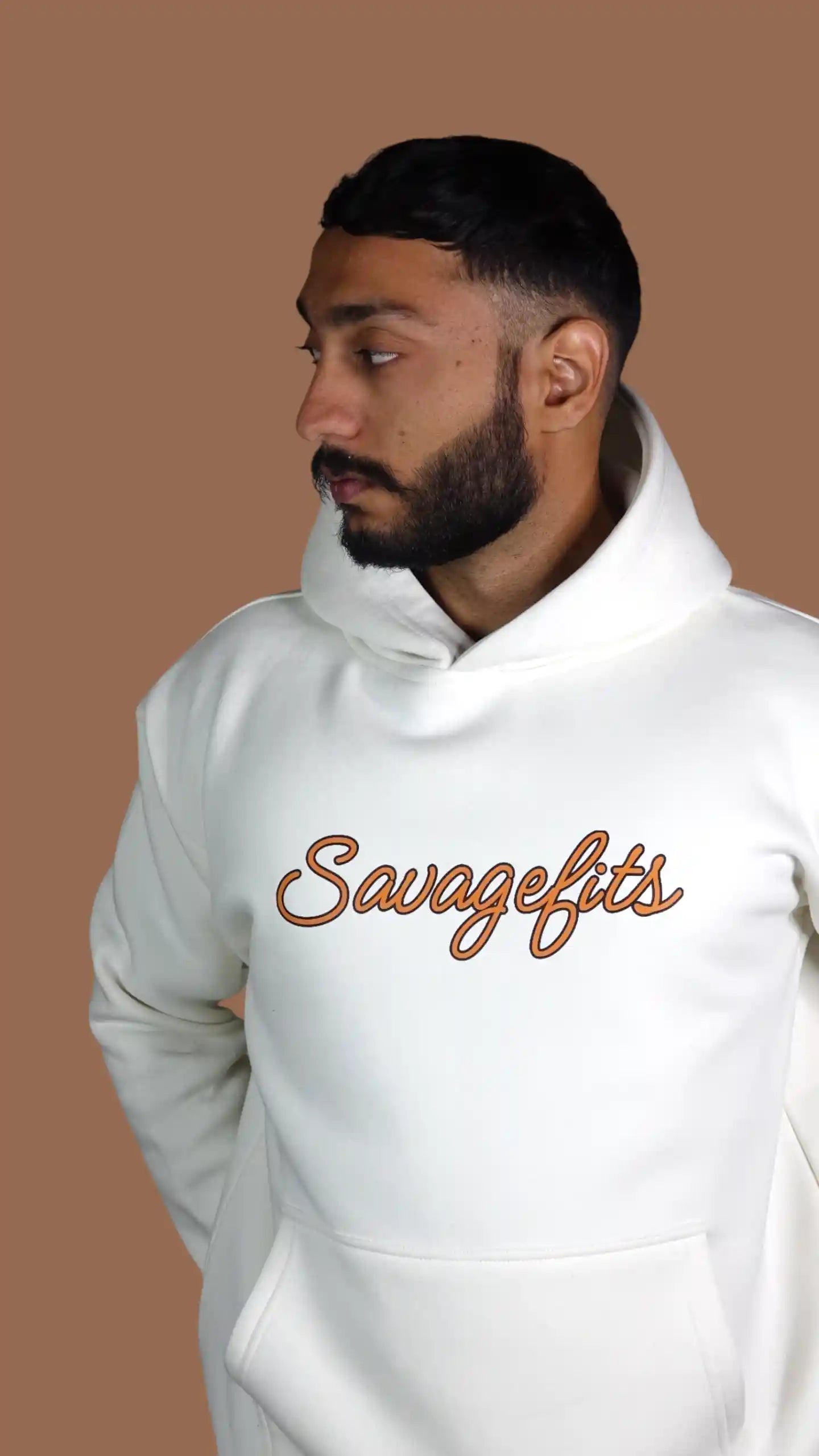 Man wearing a white hoodie with 'Savagefits' text on a brown background